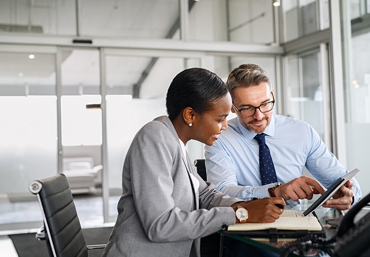 coworkers look at electronic tablet