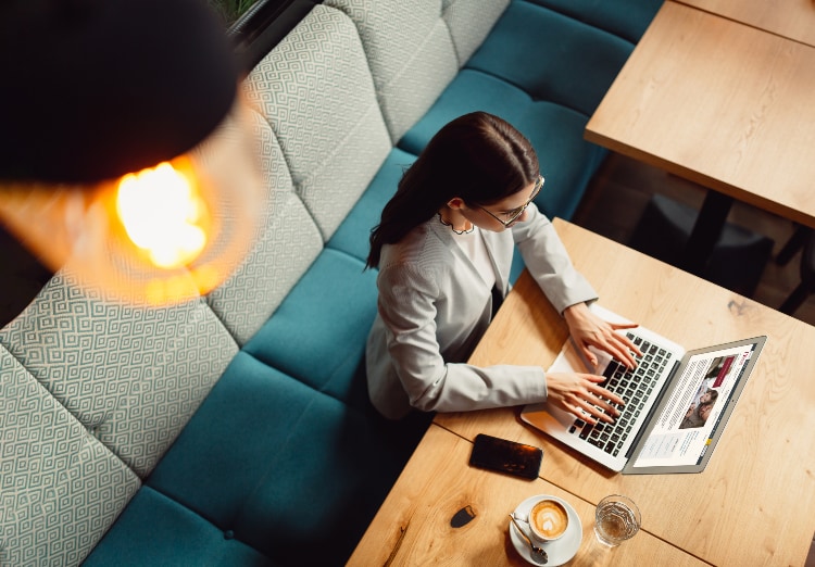 Overhead shot of woman working on laptop and table