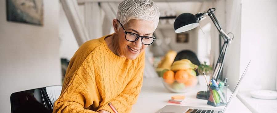 Woman works at home office desk