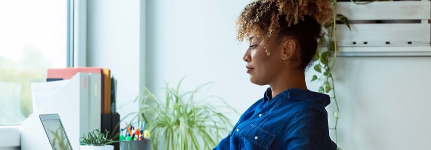 woman works on laptop in office