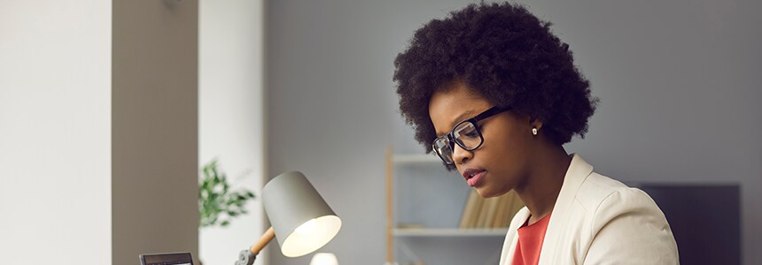 businesswoman works on laptop in office