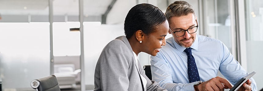 coworkers look at electronic tablet