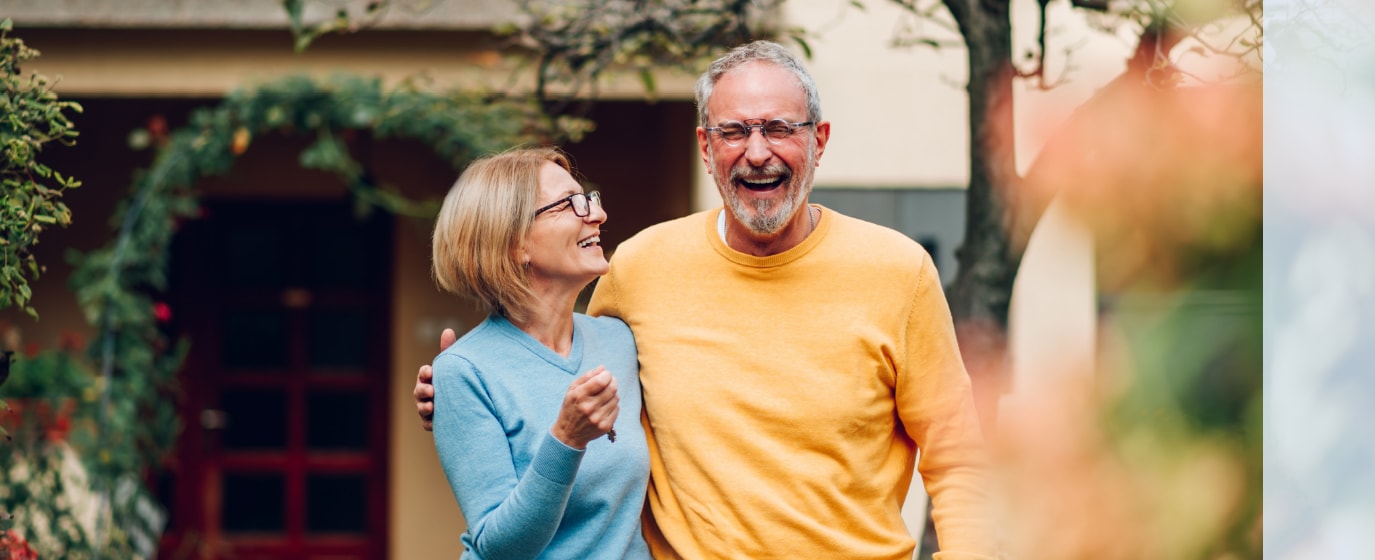 Husband and wife side hug and laugh