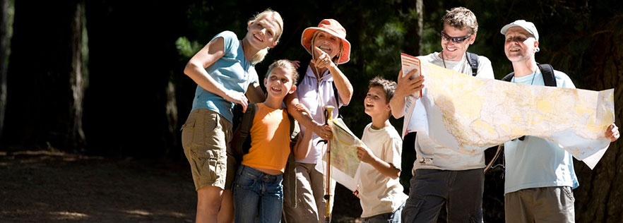 Group of people looking at a map and around at the sites.