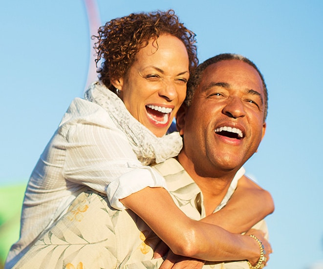 A man and woman laughing and smiling.