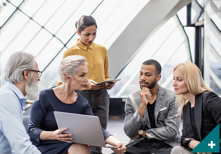 people talking while looking at computer