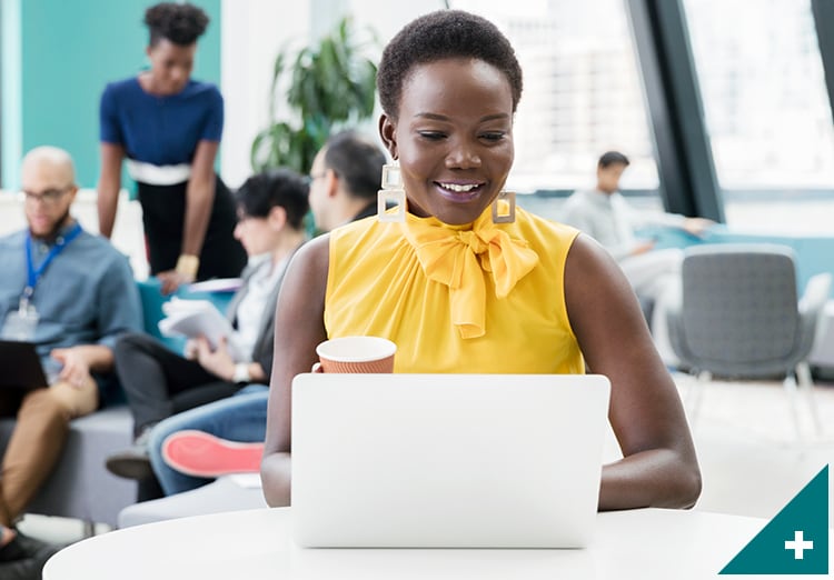 woman works on laptop in office lounge