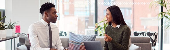 two people talking while sitting on couch