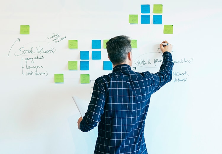 man working at whiteboard