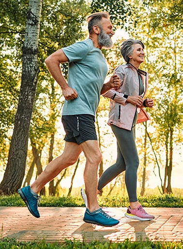 man and woman jog on path