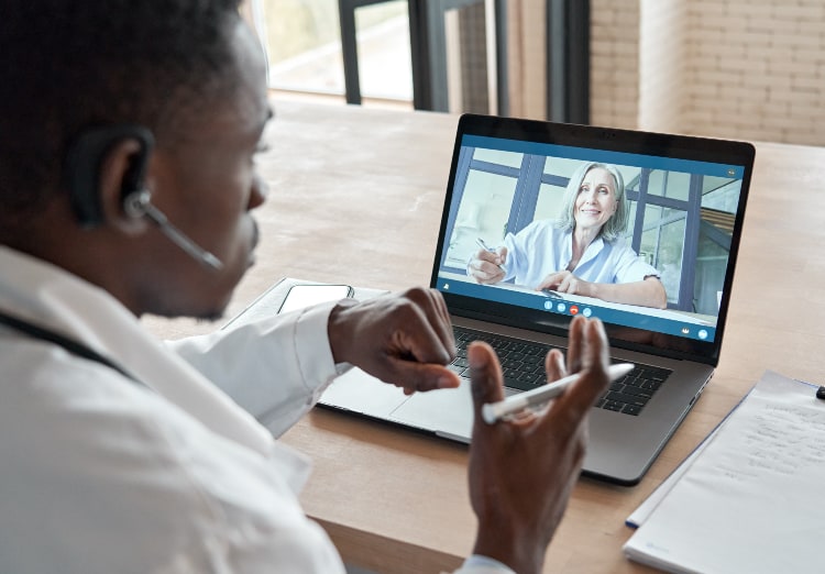 man having video conference call with woman from his laptop