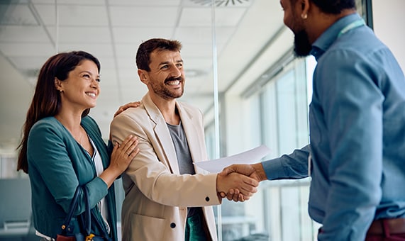 couple shakes hands with agent