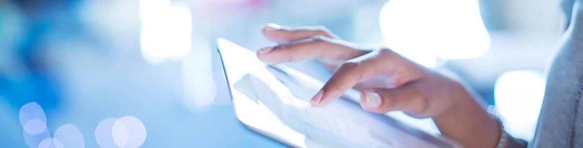 close up of hands working on electronic tablet