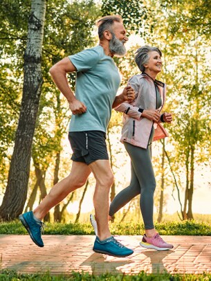 man and woman jog on path