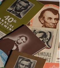 pile of old Lincoln financial brochures featuring Abe Lincoln's image