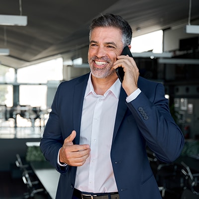 businessman talks on phone in office