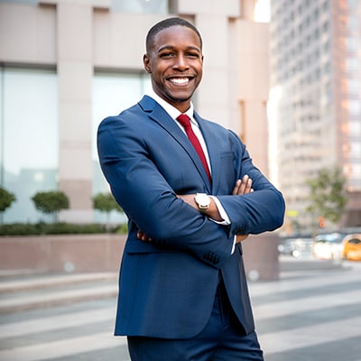 businessman stands on city street