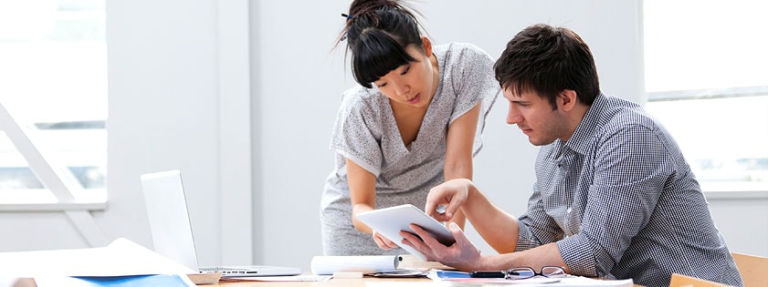 woman and man reading iPad