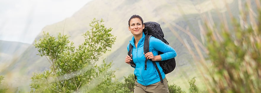 A man with a backpack smiliing. 