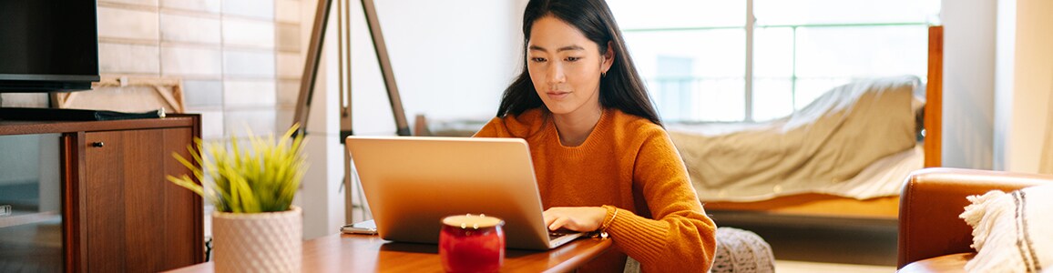 Woman working on laptop at table