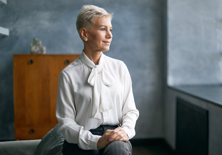 woman sits and looks off into the distance