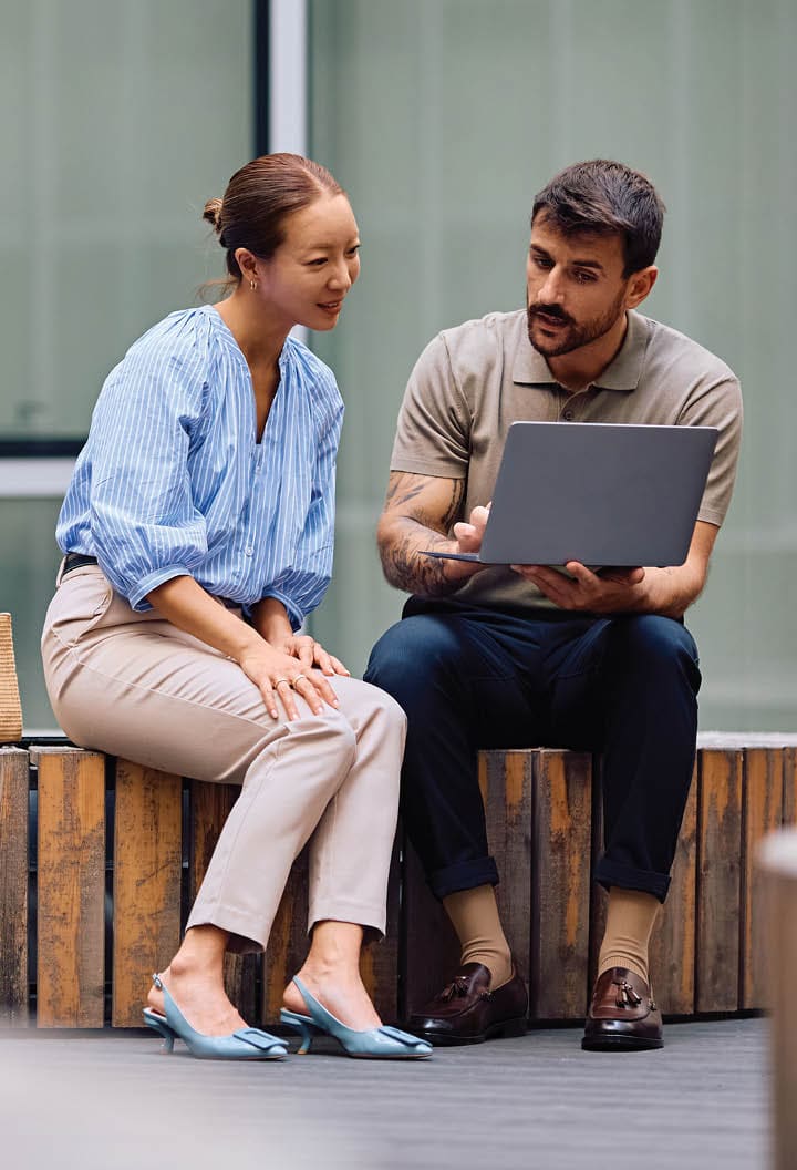coworkers looking at a laptop