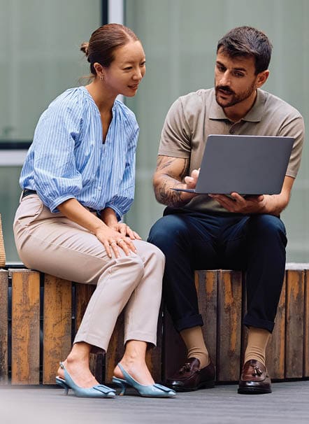 coworkers looking at a laptop
