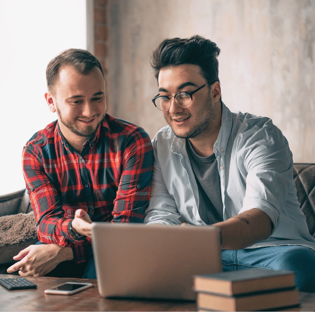 coworkers looking at a laptop