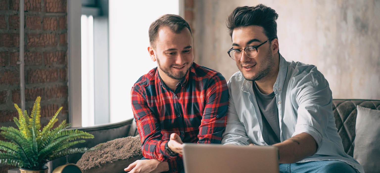 coworkers looking at a laptop