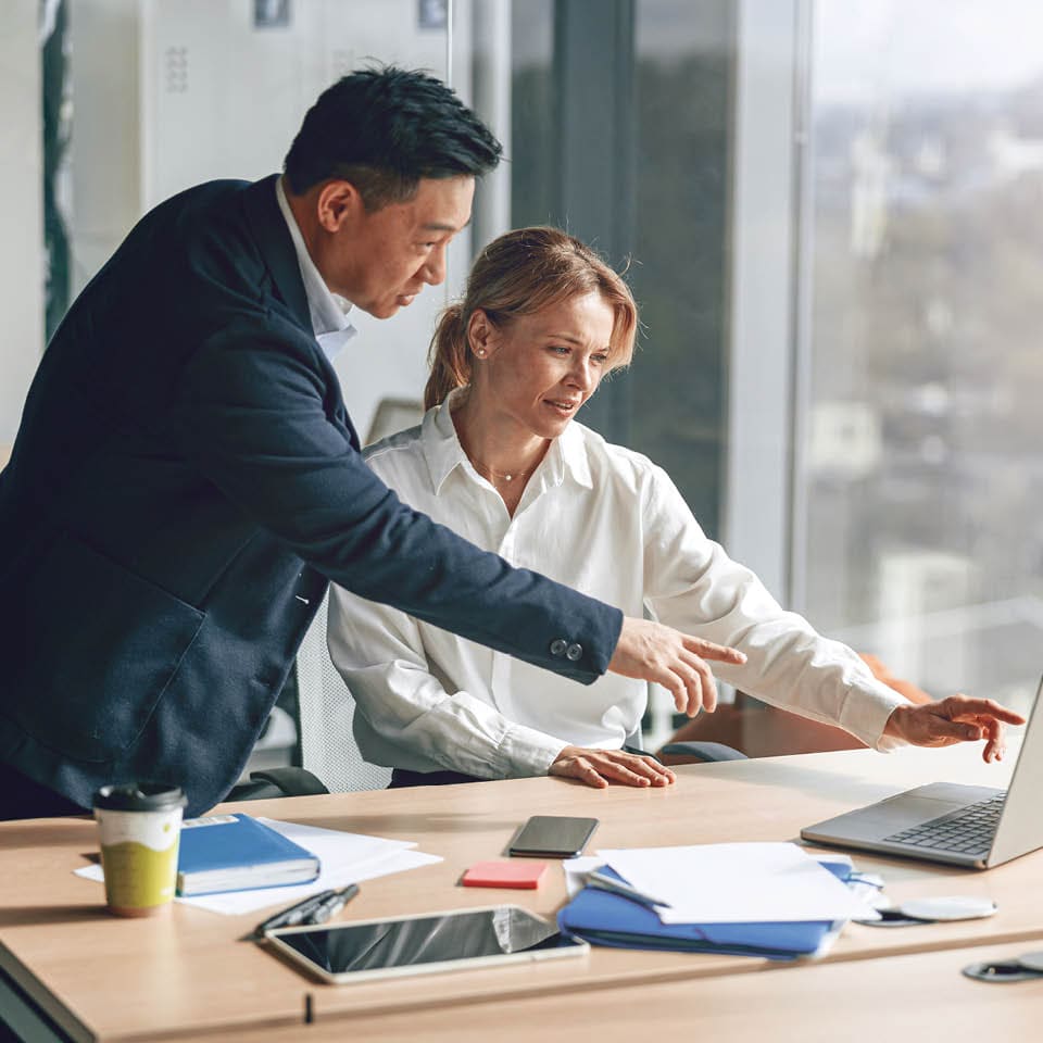coworkers looking at a laptop