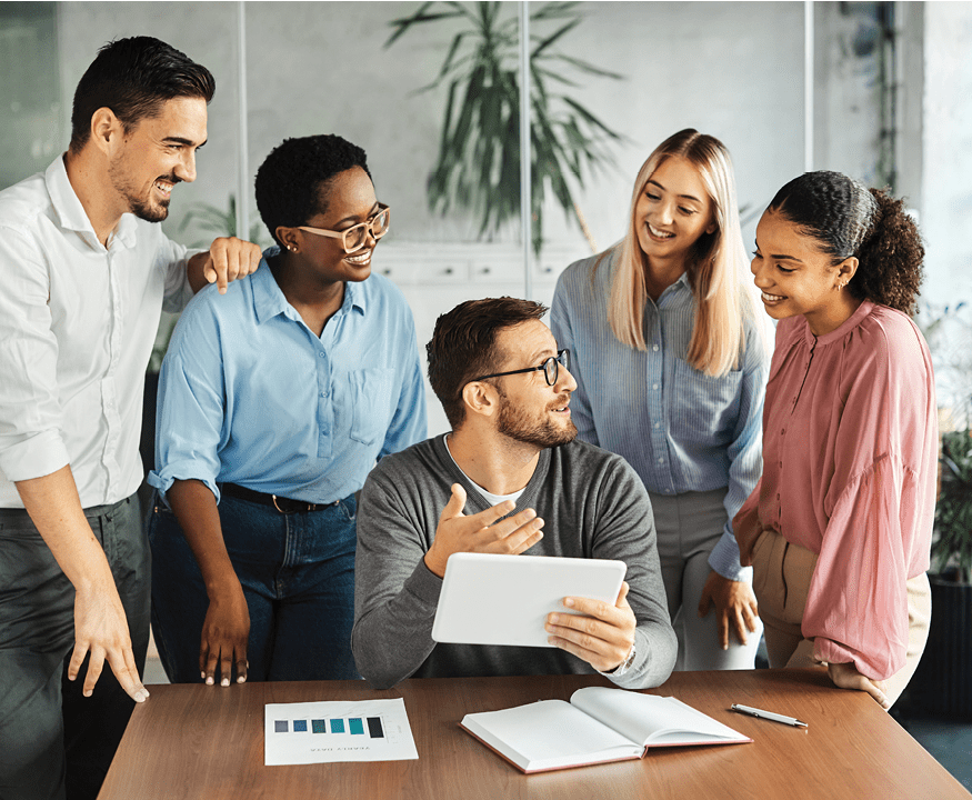 five coworkers having a meeting while looking at an electronic tablet