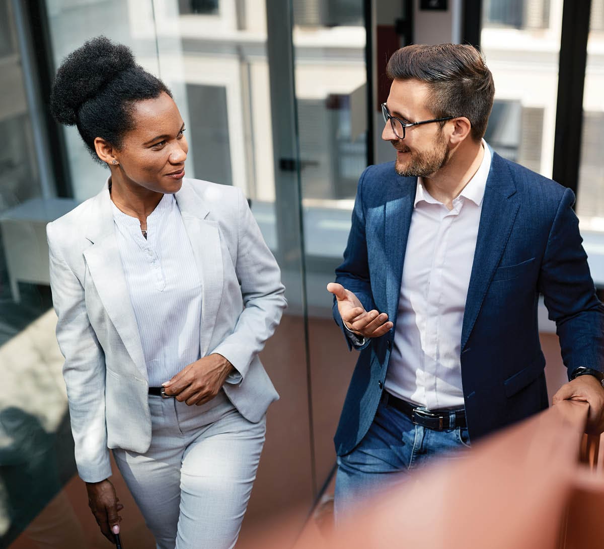 coworkers having a conversation while ascending a staircase