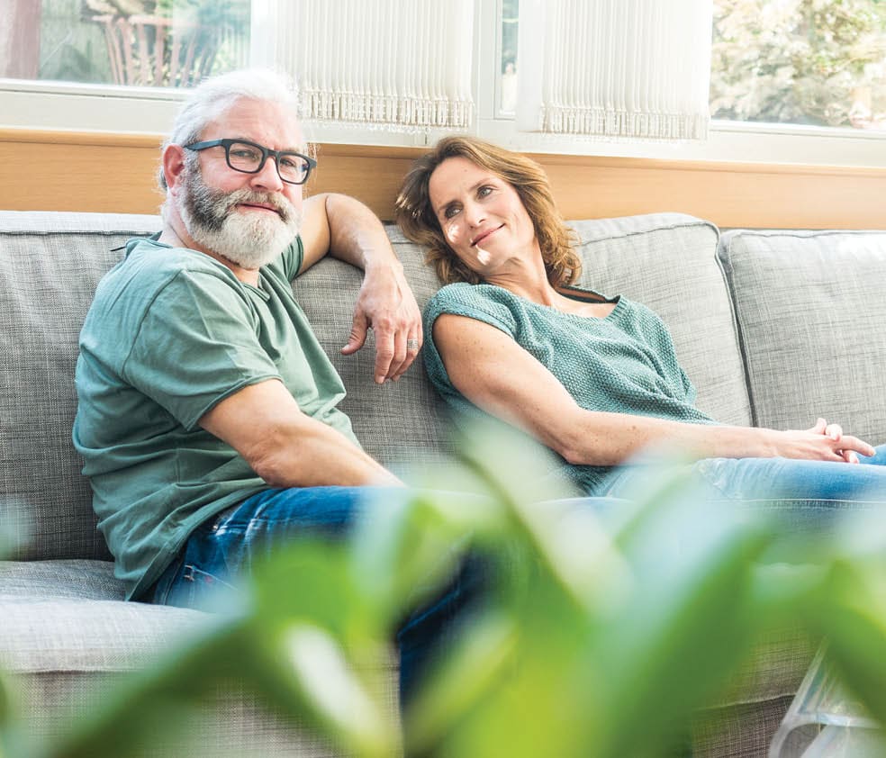 older couple sitting on a couch