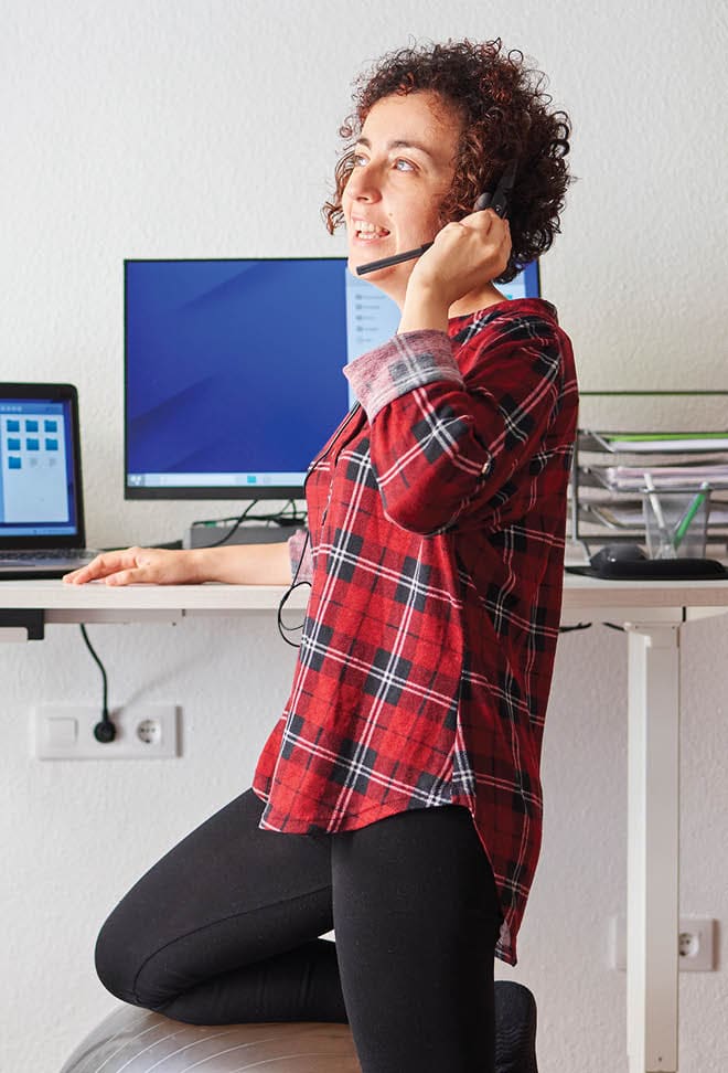 woman working in home office and talking on headset phone