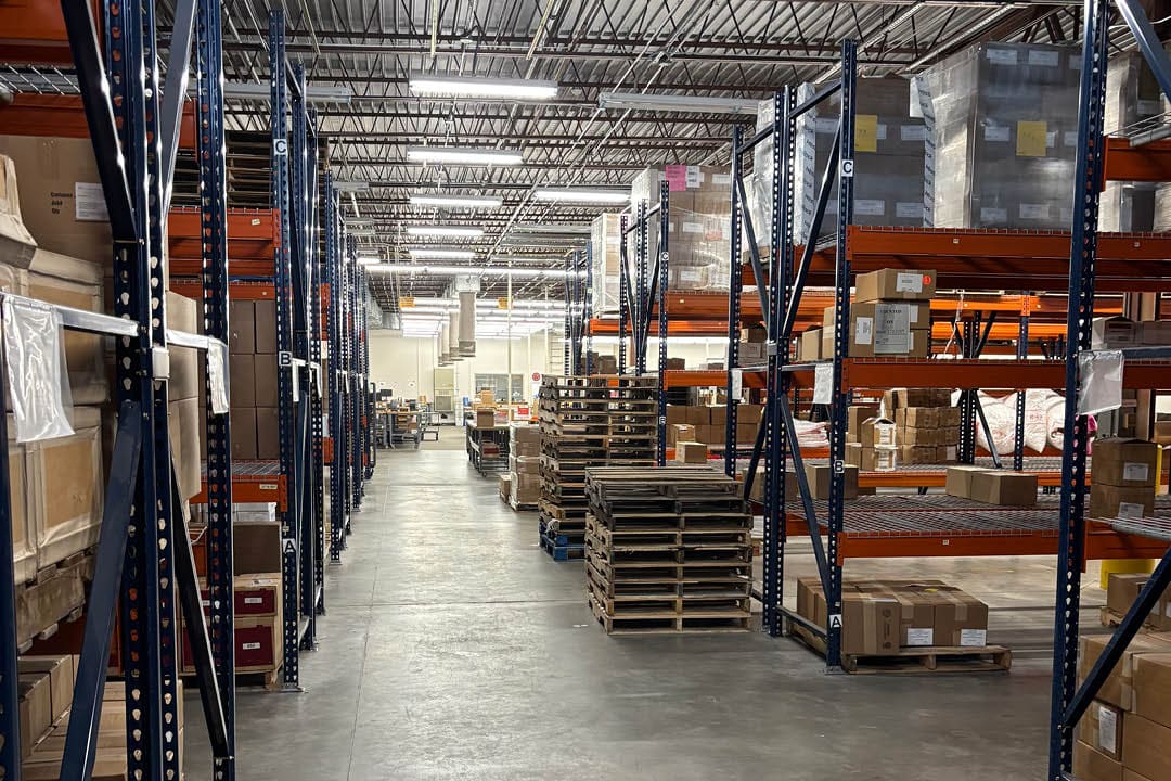 A large warehouse with shelves full of boxes and crates. AI generated content