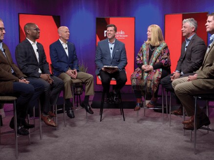Panel having discussion in studio