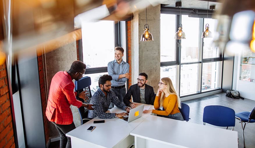 Young caucasian blonde woman accountant reports financial results of the last start-up project to multiracial company owners partners working in casual clothes, at nice comfortable light office.