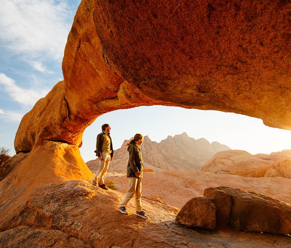 couple hiking around rock formations