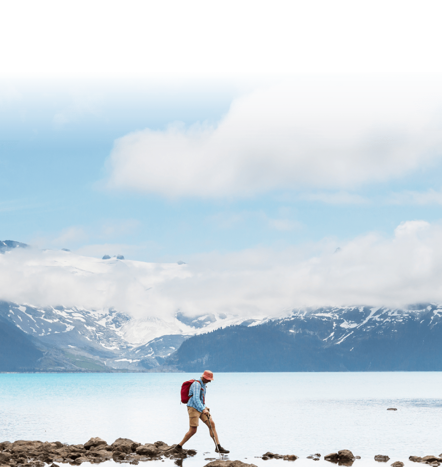 hiker walking on exposed rocks to cross water