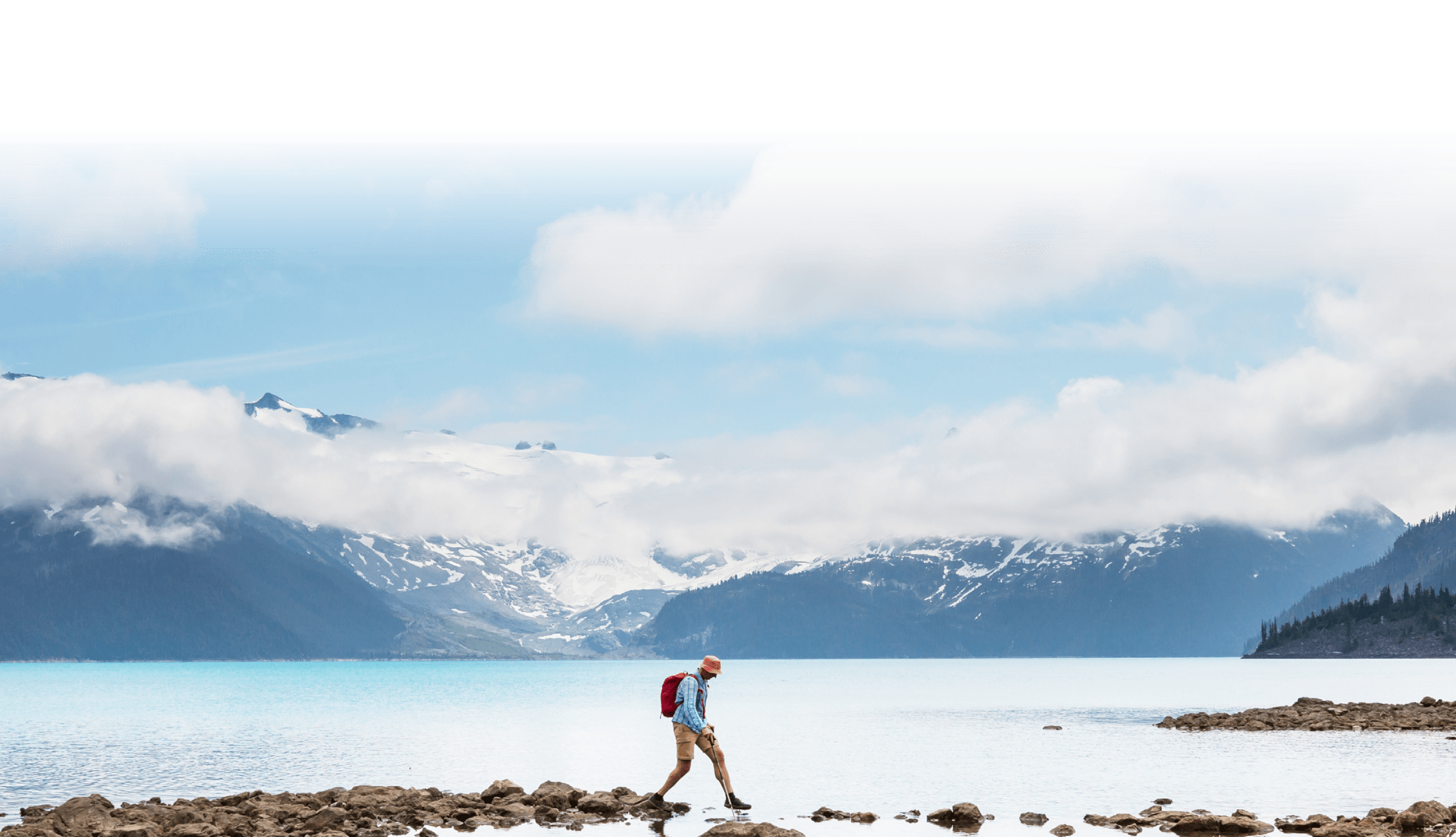 hiker walking on exposed rocks to cross water