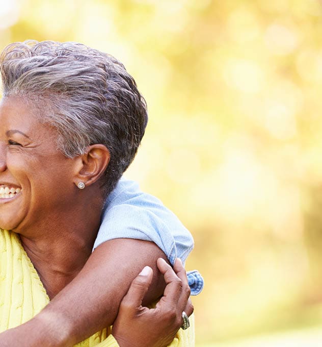 laughing older couple with arms around each other