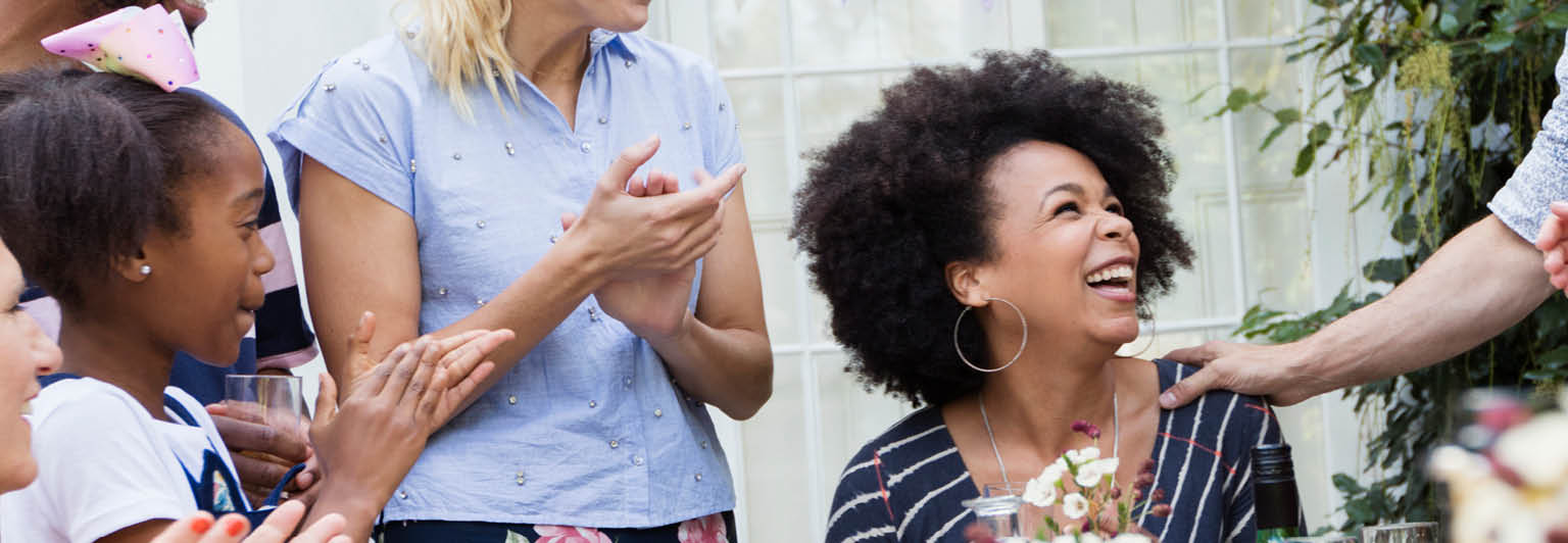 Woman surrounded by friends and family celebrating