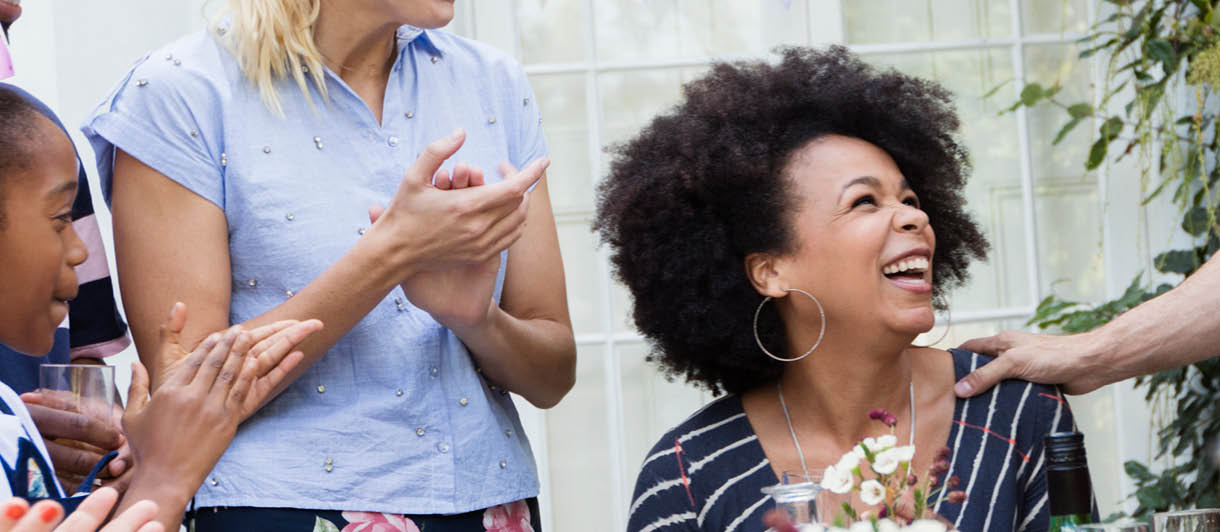 Woman surrounded by friends and family celebrating