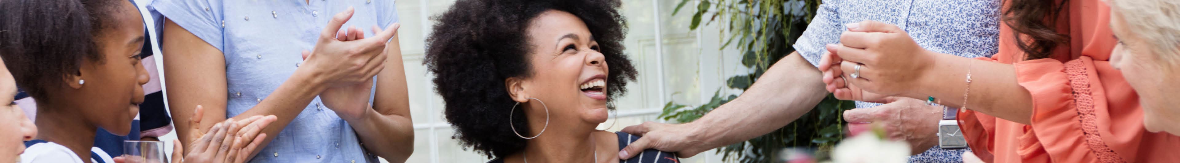 Woman surrounded by friends and family celebrating