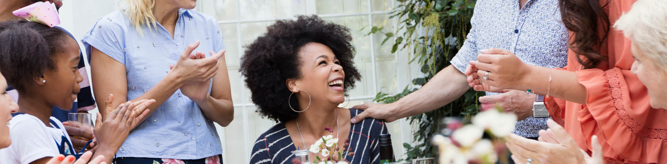 Woman surrounded by friends and family celebrating