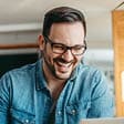 Man in glasses smiling 