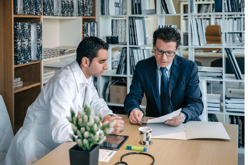 Spain, Asturias, Insurance agent showing health documents to doctor sitting in medical office