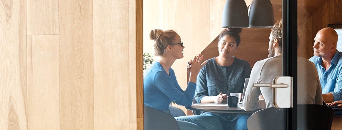 Group of people having a discussion in a conference room.