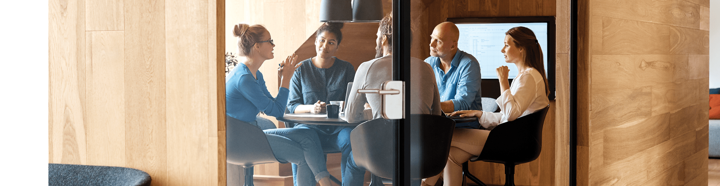 Group of people having a discussion in a conference room.
