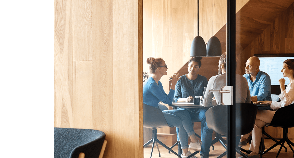Group of people having a discussion in a conference room.